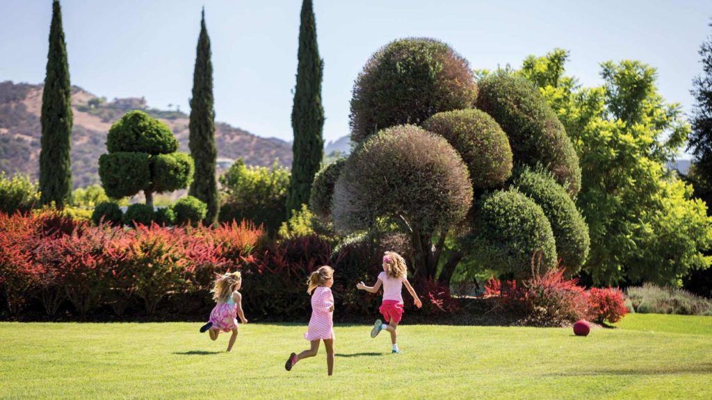 Kids playing in the gardens at Four Seasons Westlake Village as part of the best things to di in Westlake Village